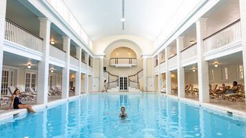 Relax by the pool surrounded by lounge chairs and take in the views from the upper level balcony.