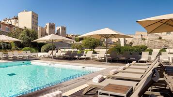 Seasonal outdoor pool, open 8:00 AM to 10:00 PM, pool umbrellas