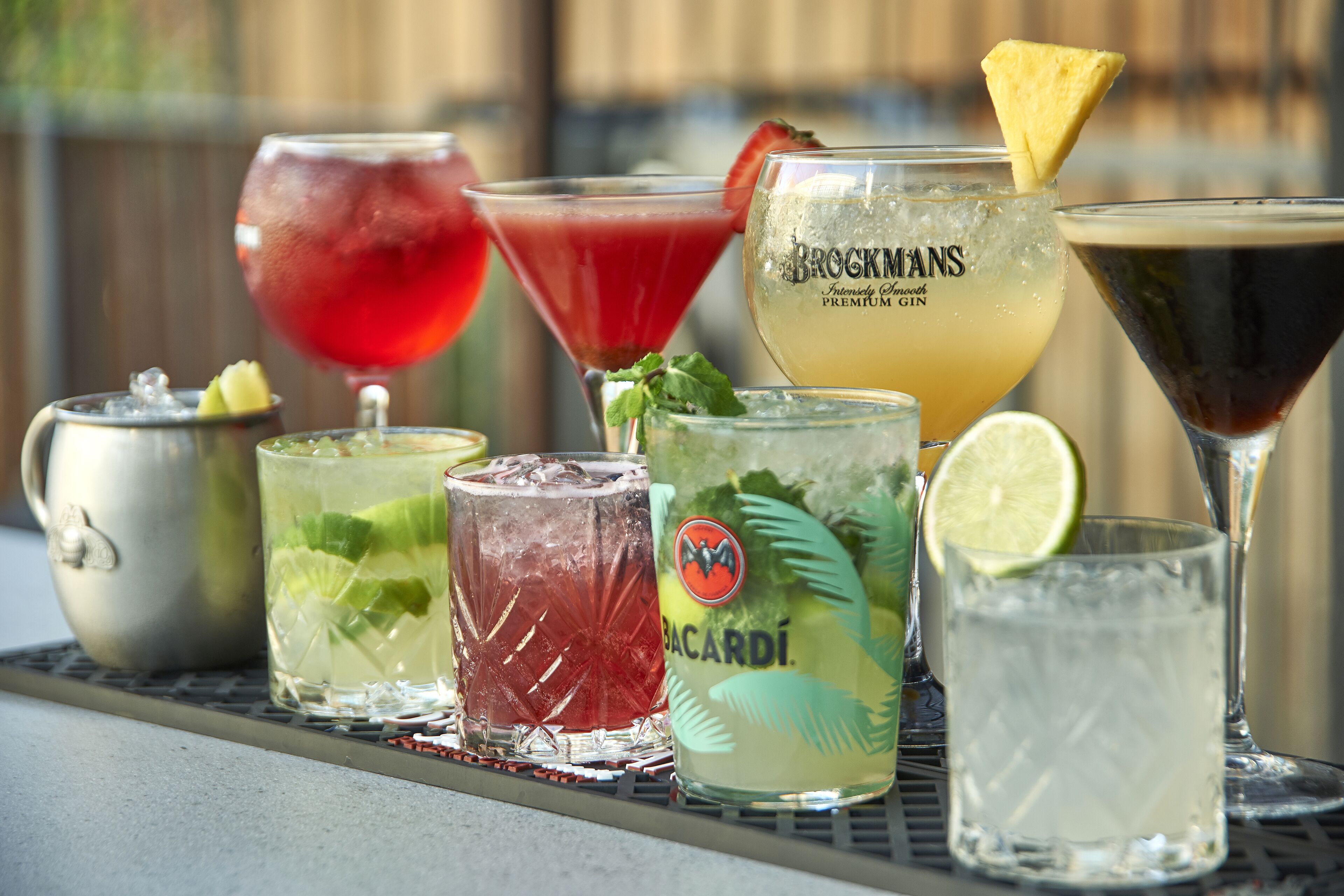 A variety of cocktails on a tray.