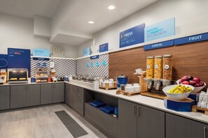 A modern breakfast area with labeled sections for breakfast, hot food, cereal, and fruit. - Holiday Inn Express Dumfries by IHG (Dumfries)