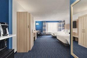 A hotel room with a kitchenette, a desk, two beds, and a large mirror. - Holiday Inn Express Dumfries by IHG (Dumfries)
