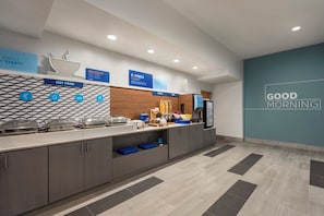 A modern breakfast area with a counter displaying hot food, cereal, and fruit options. - Holiday Inn Express Dumfries by IHG (Dumfries)