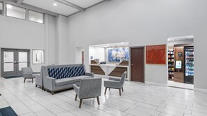 A spacious lobby with a reception desk, seating area, and vending machine. - Holiday Inn Express Hotel & Suites San Dimas by IHG (San Dimas)