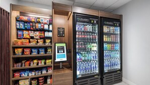 A self-serve kiosk with snacks and a payment terminal. - Holiday Inn Express Hotel & Suites San Dimas by IHG (San Dimas)