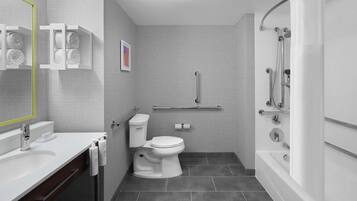 Un baño moderno con inodoro, lavamanos y ducha.