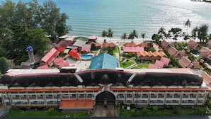 Ein Küstenhotel mit mehreren Gebäuden, einem Pool und Blick auf den Ozean.