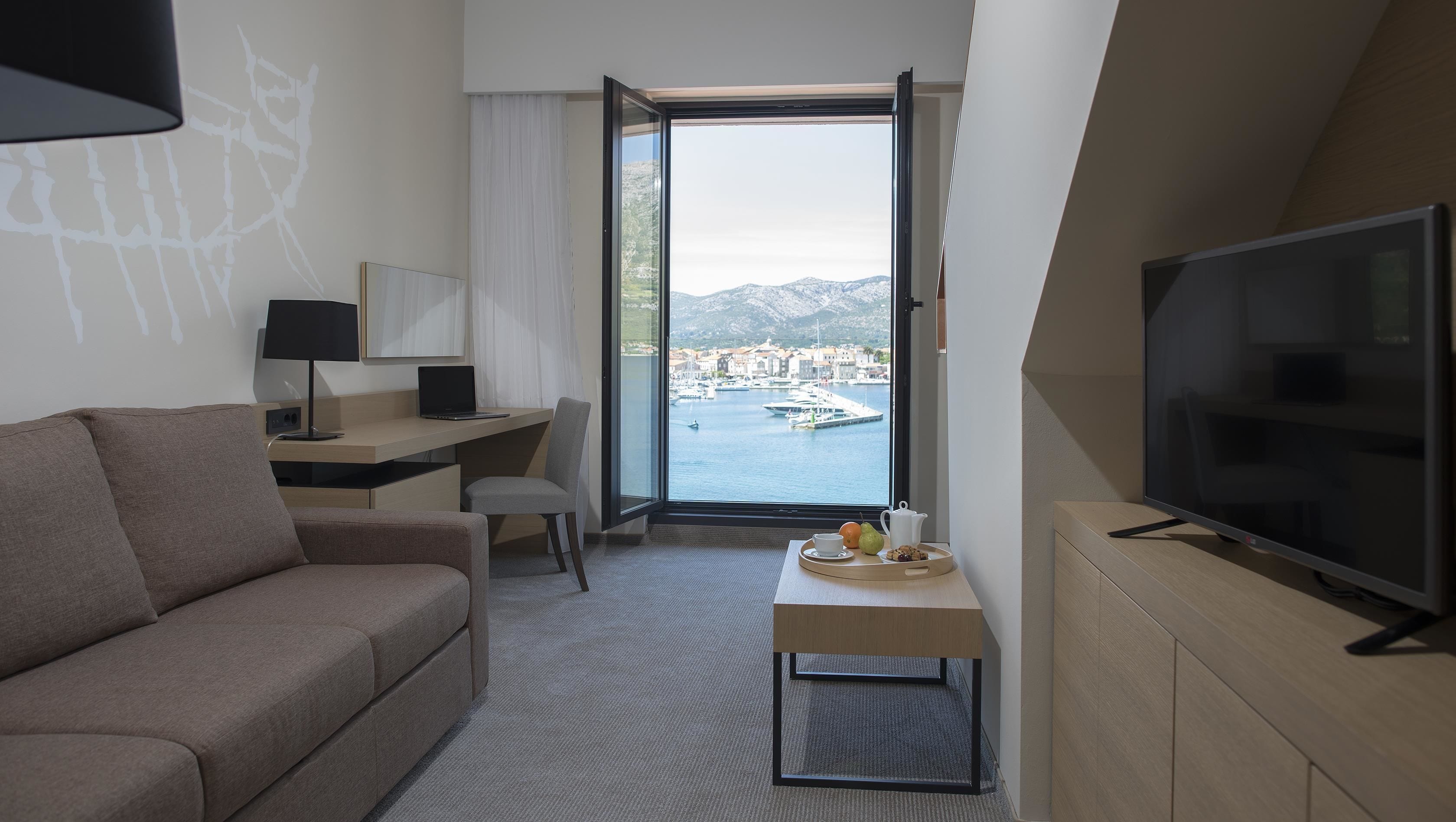 superior suite with seaside balcony | living area | 56-inch led tv with satellite channels, tv