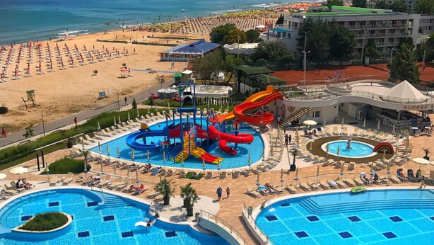 A resort with multiple swimming pools, a water park, and a beach area.