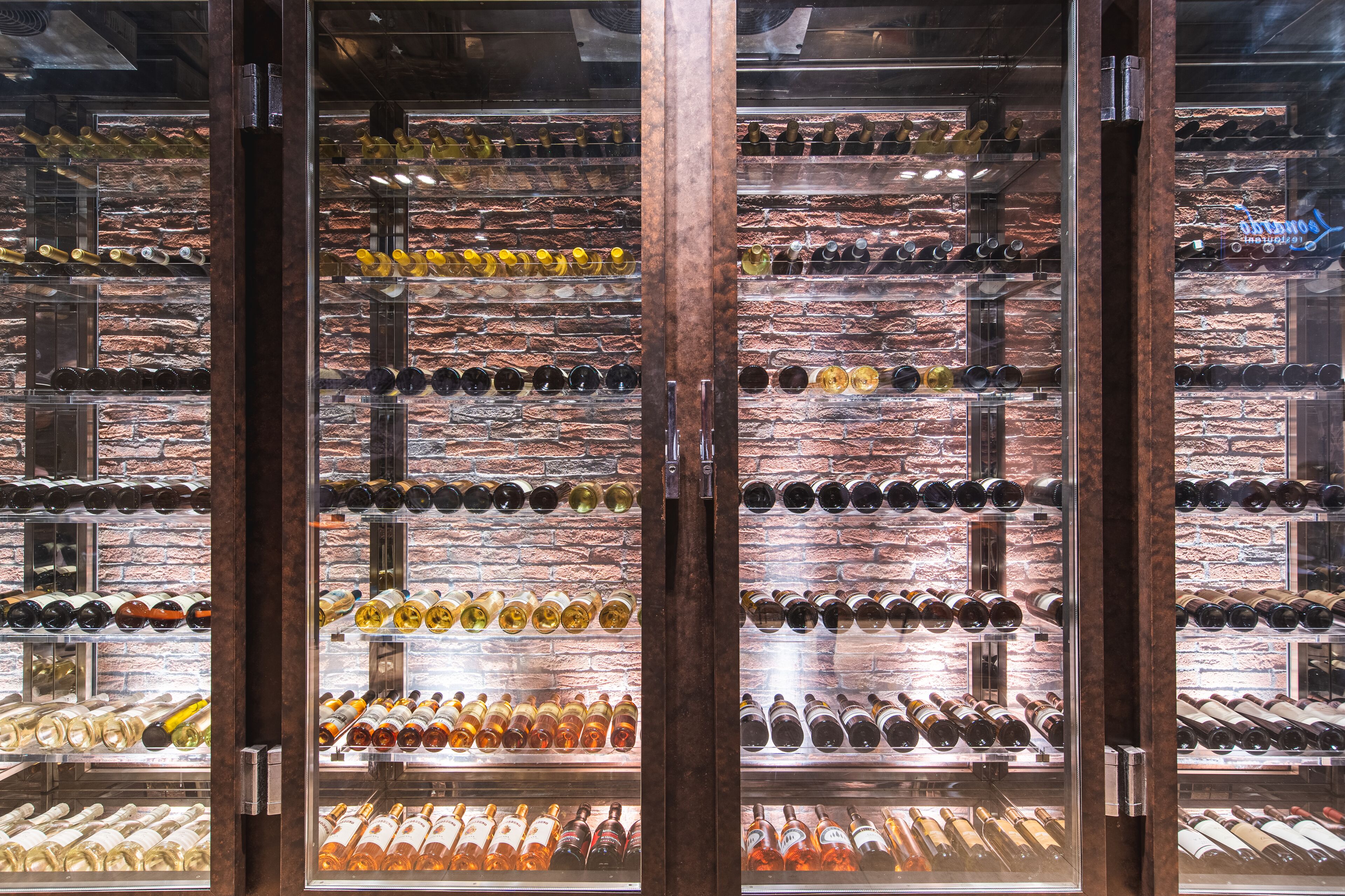 A wine cellar with multiple shelves of wine bottles.