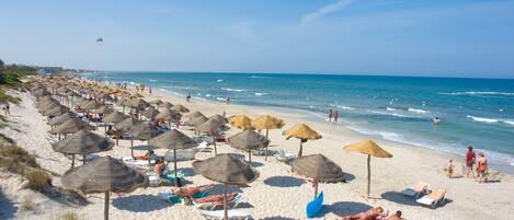 Private beach, white sand, sun loungers, beach umbrellas