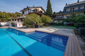 A hotel with a swimming pool, a traditional building, and a modern structure. - Santa Susanna Resort Affiliated by FERGUS (Santa Susanna)