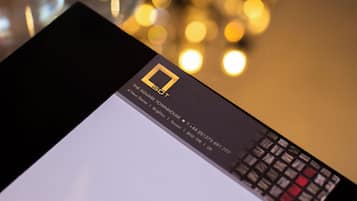 A table with a black wallet, clear glass bottles, and a card with text.