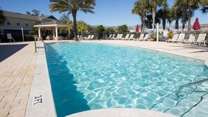 A clear swimming pool with lounge chairs and palm trees. - Coral Cay Resort by Sky Hotels & Resorts (Kissimmee)