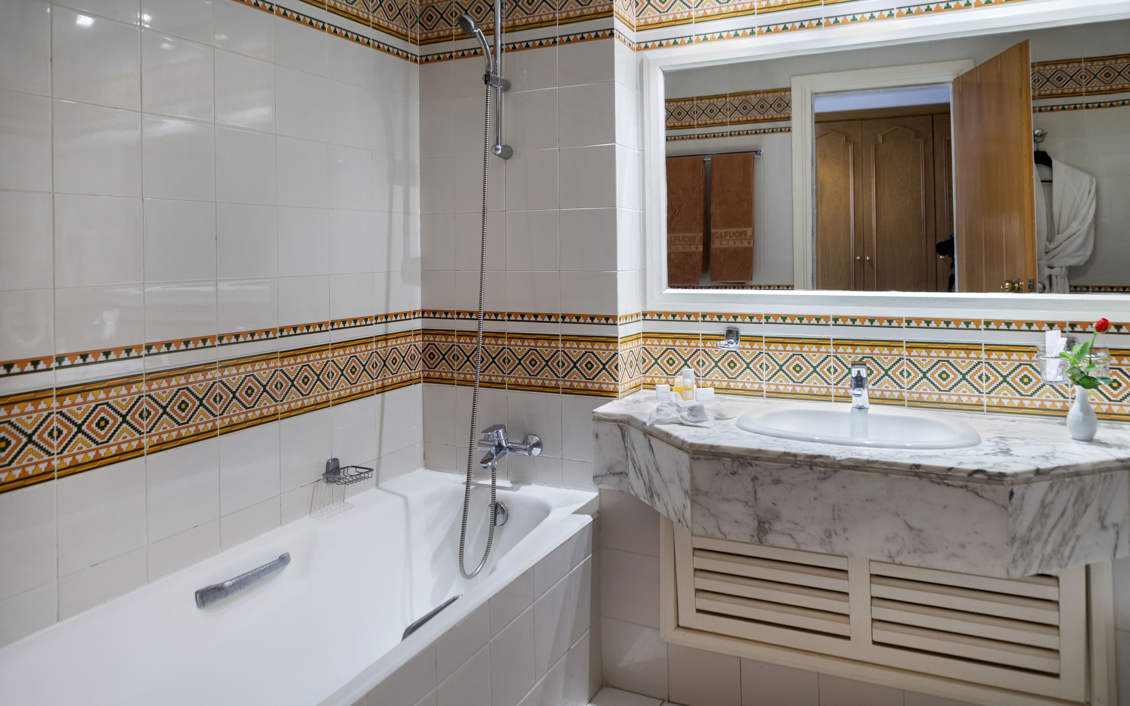 A bathroom with a bathtub, a sink, and a shower.
