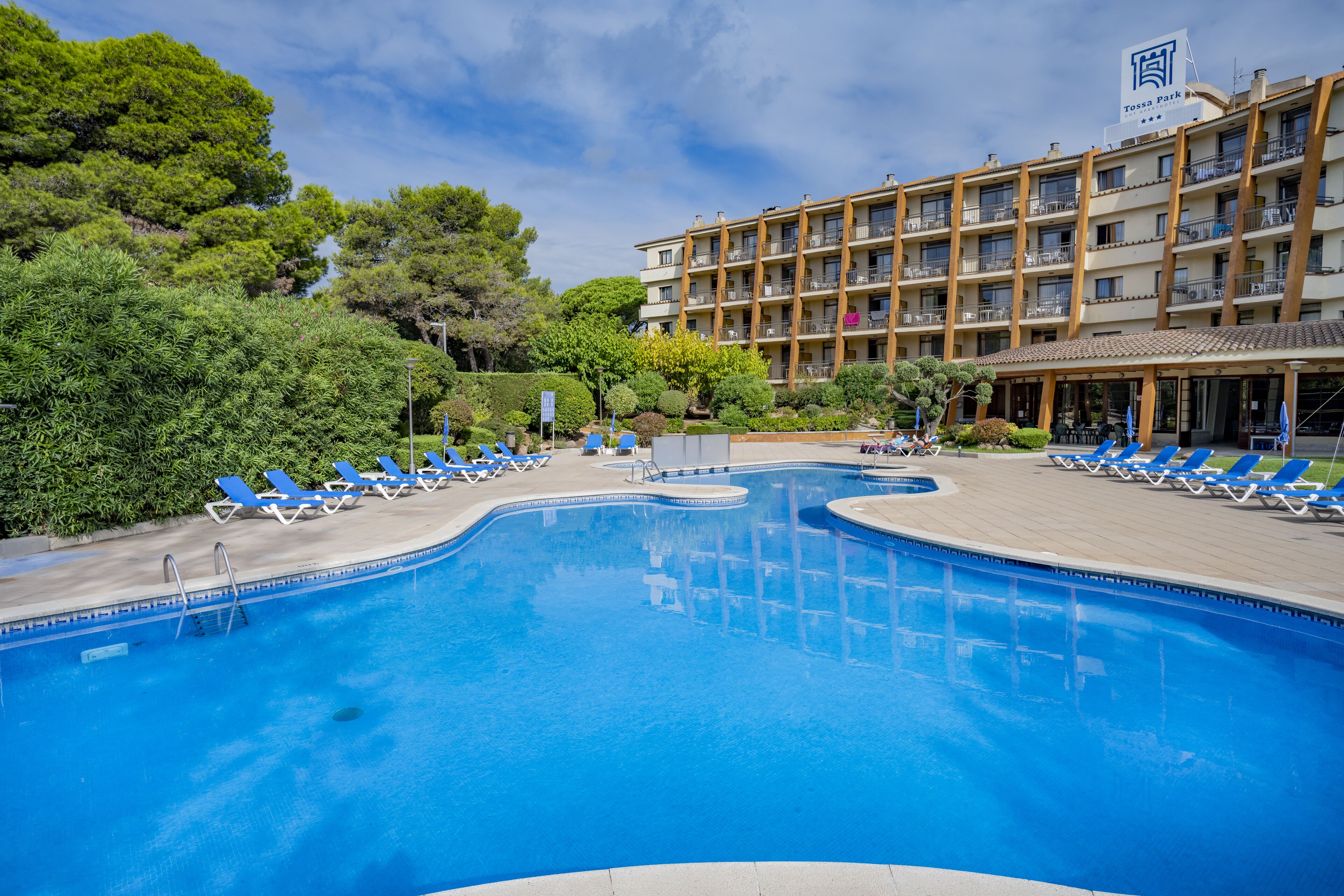 Una piscina cubierta, una piscina al aire libre de temporada, sombrillas