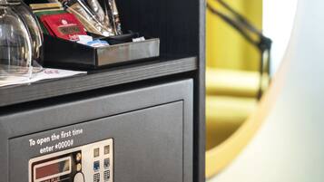 A secure room with a keypad lock, a safe, and a glass display case with keys.