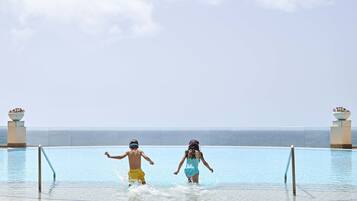 Indoor pool, open 8:00 AM to 8:00 PM, pool umbrellas, pool loungers