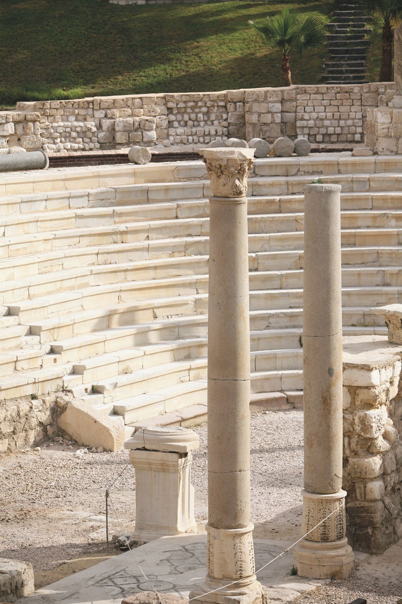 Ancient stone steps leading up to a set of columns, likely part of a historical site.
