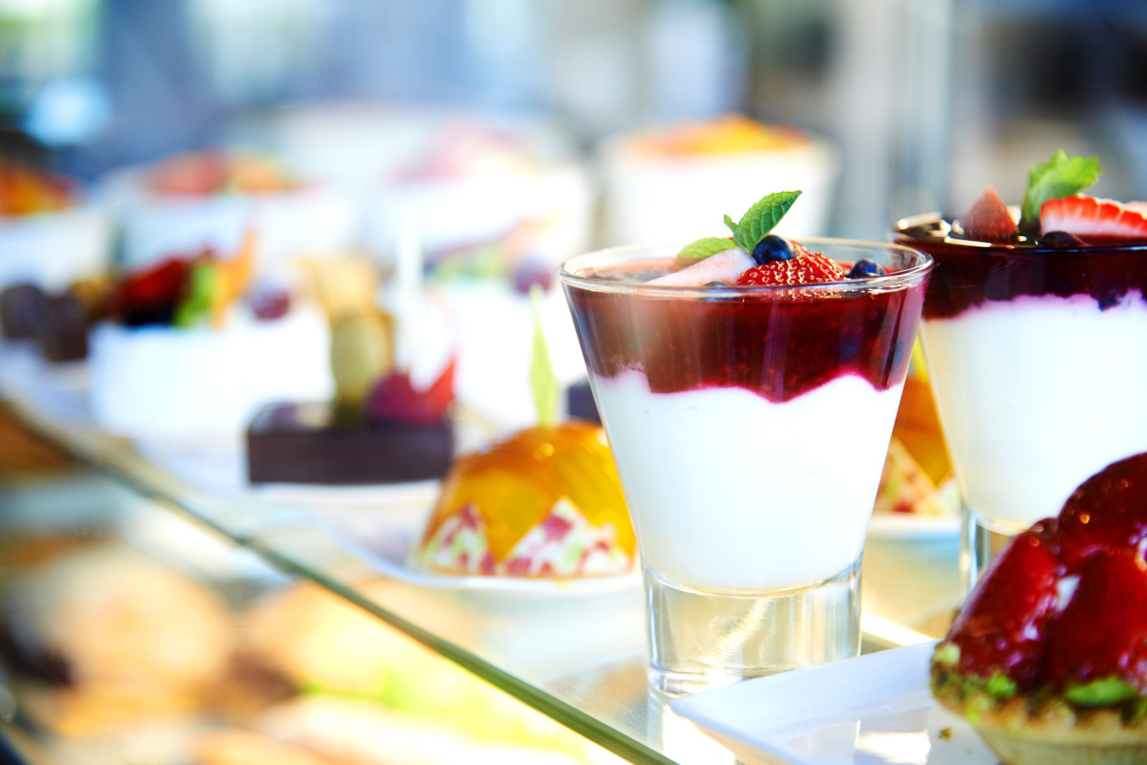 A dessert display with various layered treats and garnishes.