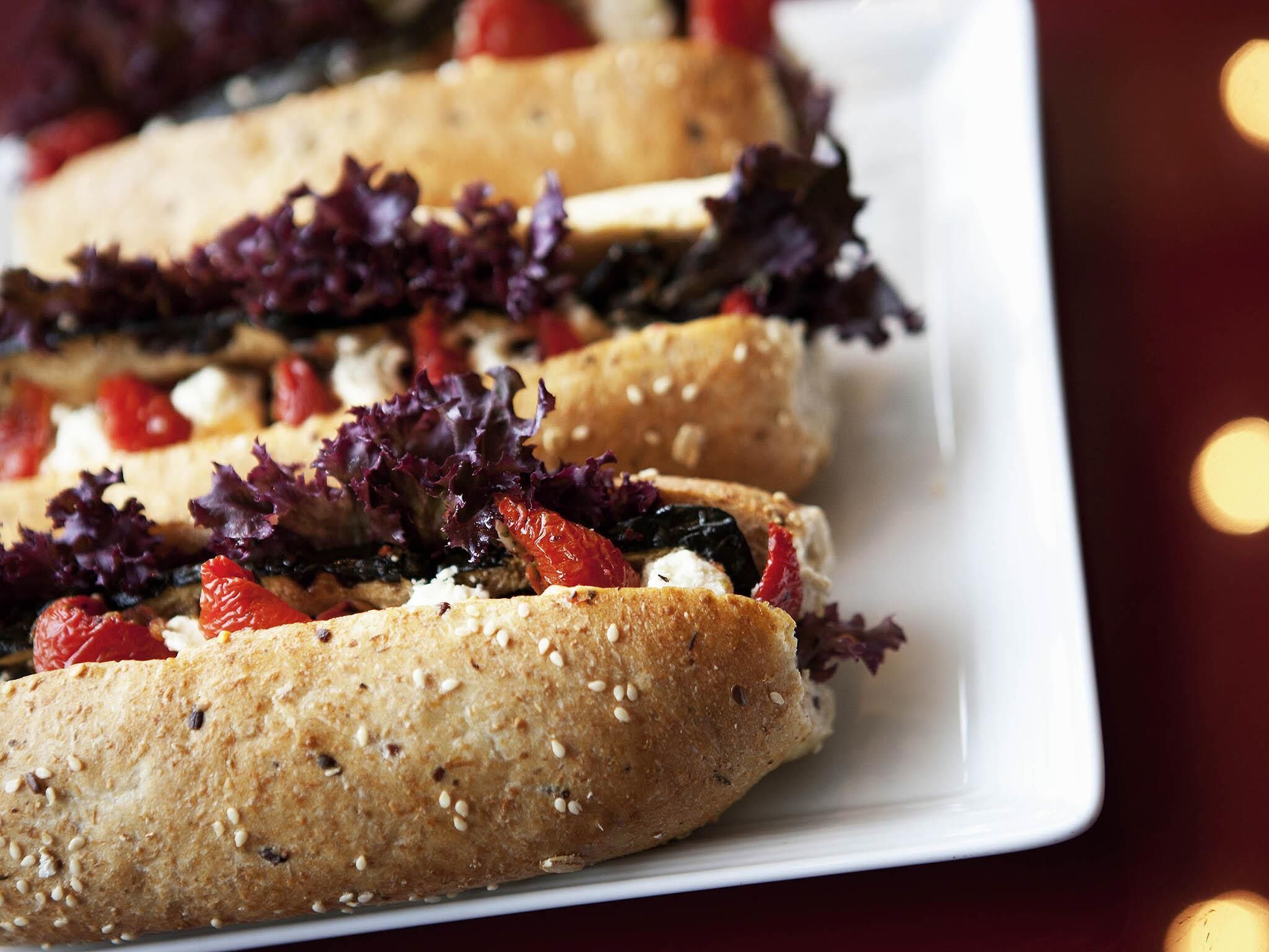 A plate of flatbreads topped with vegetables and cheese.