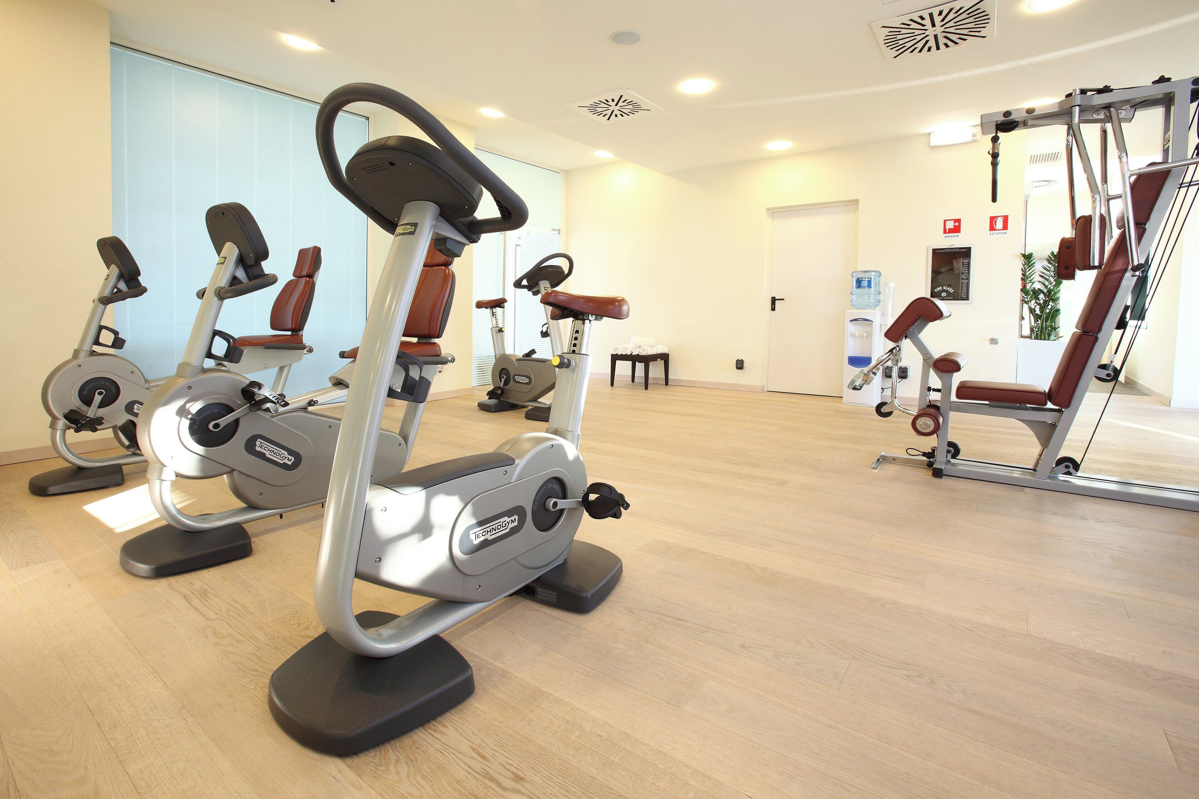 A gym with stationary bikes, treadmills, and a rowing machine.