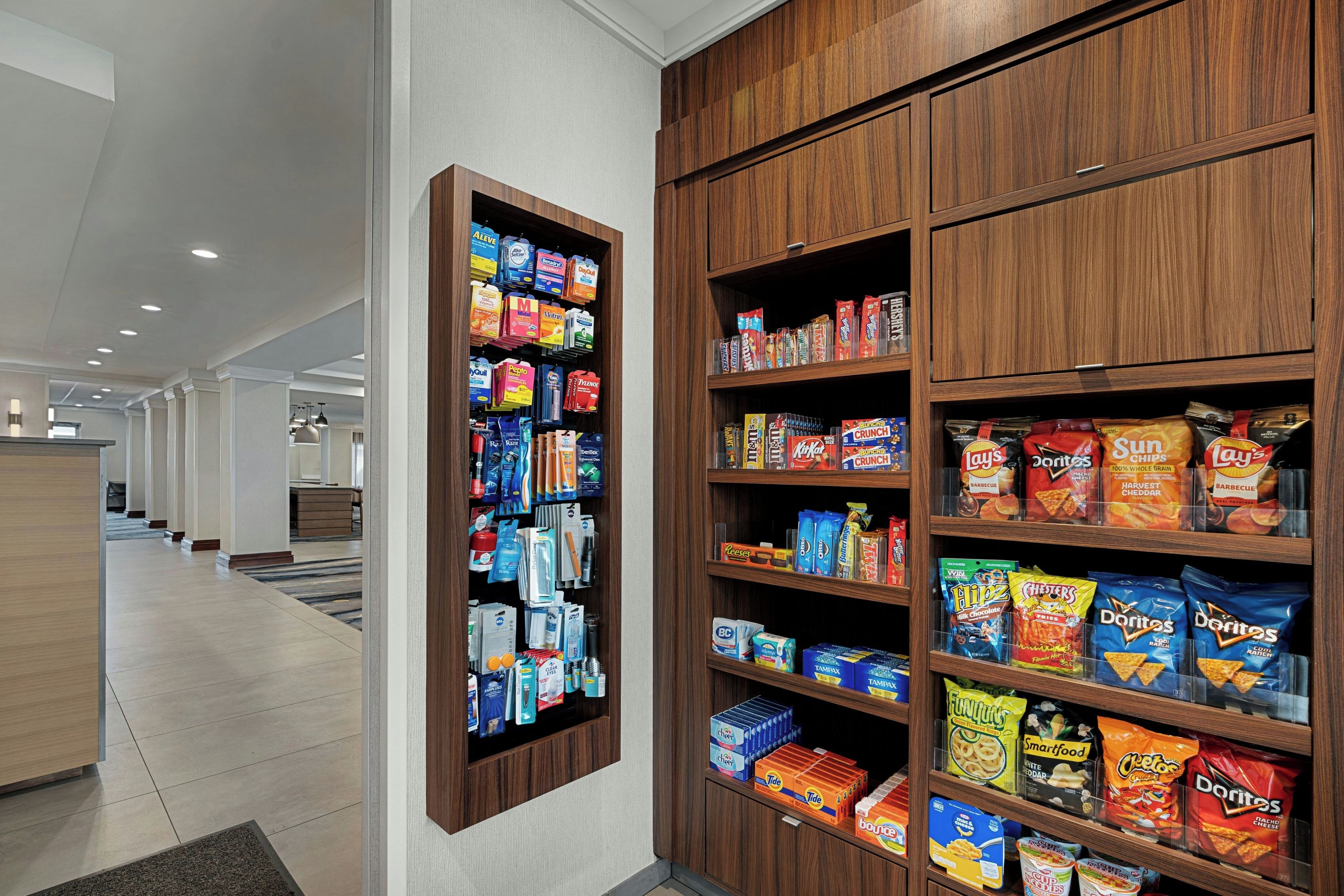 A corridor with a snack display and a reception area.