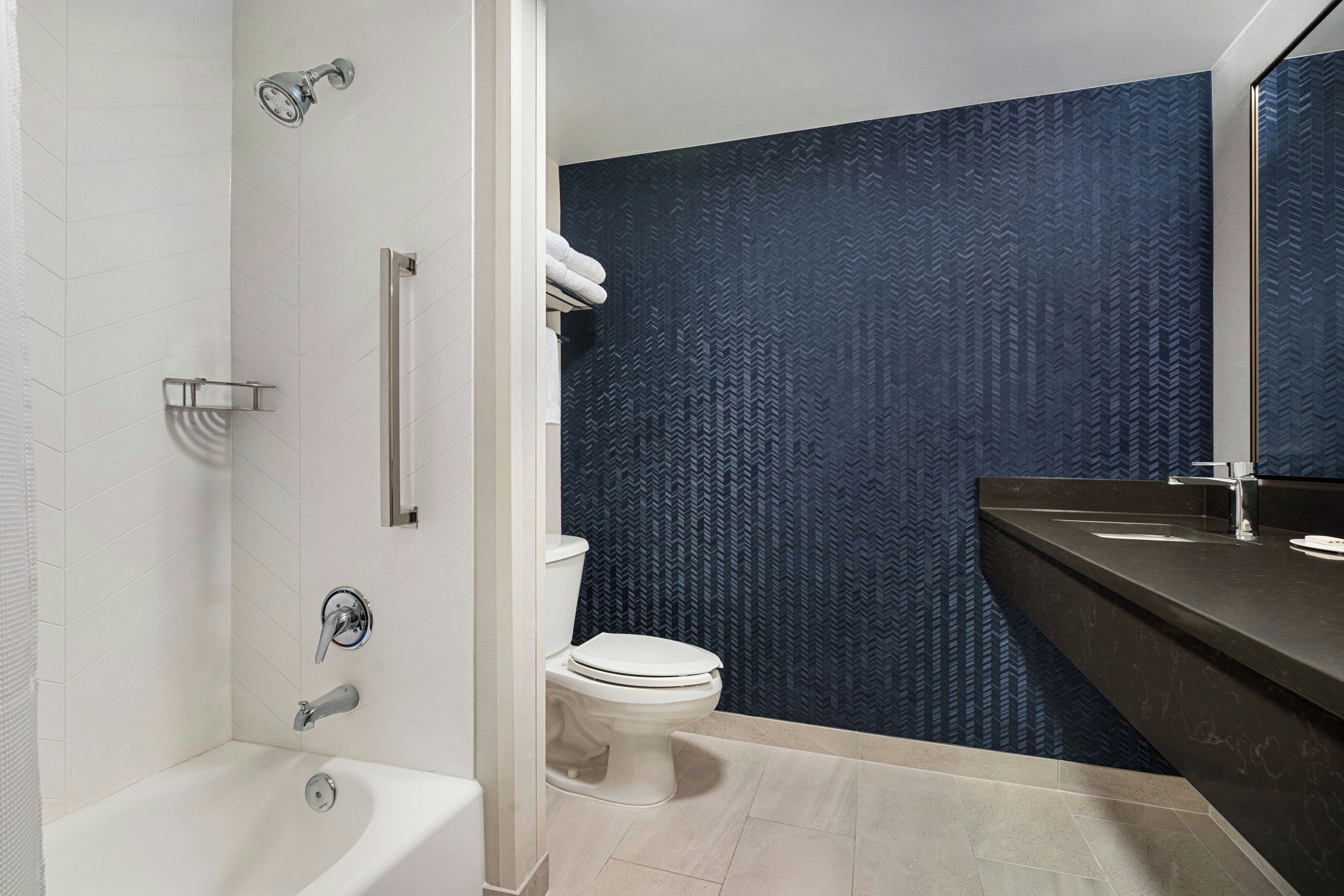 Un baño moderno con bañera, inodoro y ducha.