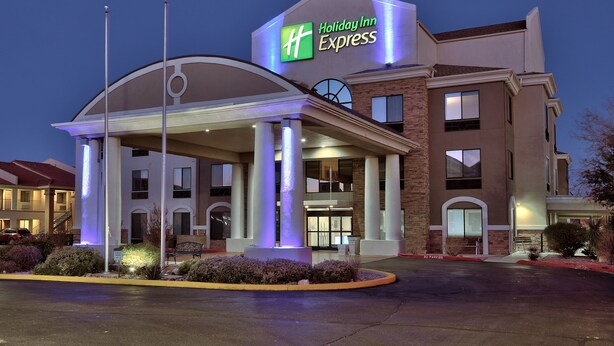 A Holiday Inn Express building with a prominent sign, a covered entrance, and a landscaped area with shrubs. - Holiday Inn Express Socorro by IHG (Socorro)