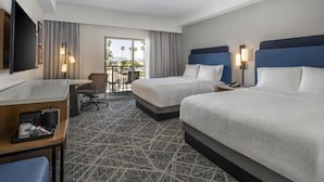 A hotel room with two beds, a desk, a chair, a TV, and a balcony with a view. - Hampton Inn Channel Islands Harbor/Oxnard (Oxnard)