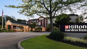 A Hilton Garden Inn with a well-maintained lawn, a covered entrance, and a prominent sign. - Hilton Garden Inn Harrisburg East (Harrisburg)