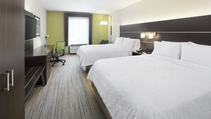 A hotel room with two beds, a desk with a flat-screen TV, a chair, and a large window.