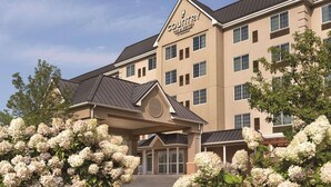 A Country Inn & Suites building with a beige facade, multiple windows, and a covered entrance.