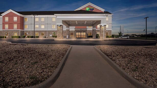A hotel with a central entrance, multiple floors, and a stone facade. - Holiday Inn Express Ada by IHG (Ada)