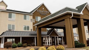 A Country Inn & Suites by Radisson building with a covered entrance and multiple windows. - Country Inn & Suites by Radisson, Winchester, VA (Winchester)