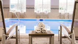 A poolside area with lounge chairs and a stack of towels on a table. - Country Inn & Suites by Radisson, Winchester, VA (Winchester)