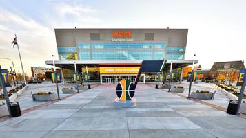 A modern building with a sign reading 'vivint. SmartHome Arena'.