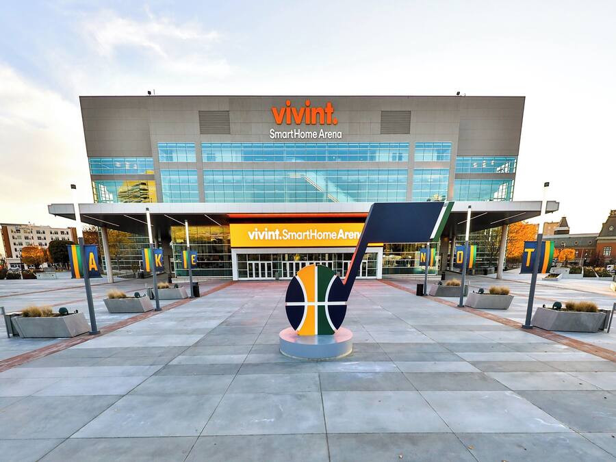 A modern building with a sign reading 'vivint. SmartHome Arena'.