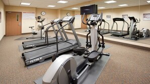 A fitness center with treadmills, elliptical machines, and a stationary bike.
