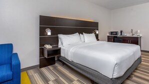 A hotel room with a large bed, a desk with a telephone, a microwave, and a coffee maker. - Holiday Inn Express & Suites Morristown by IHG (Morristown)