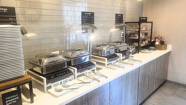A buffet area with various food stations, including a hot foods section and a bakery. - Holiday Inn Odessa by IHG (Odessa)