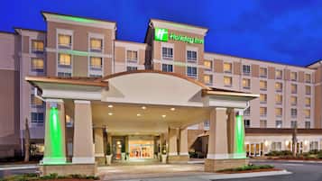 A Holiday Inn hotel entrance with a covered walkway and a sign above the entrance.