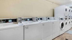 A row of commercial washers and dryers in a laundry facility. - Extended Stay America Select Suites - Laredo (Laredo)
