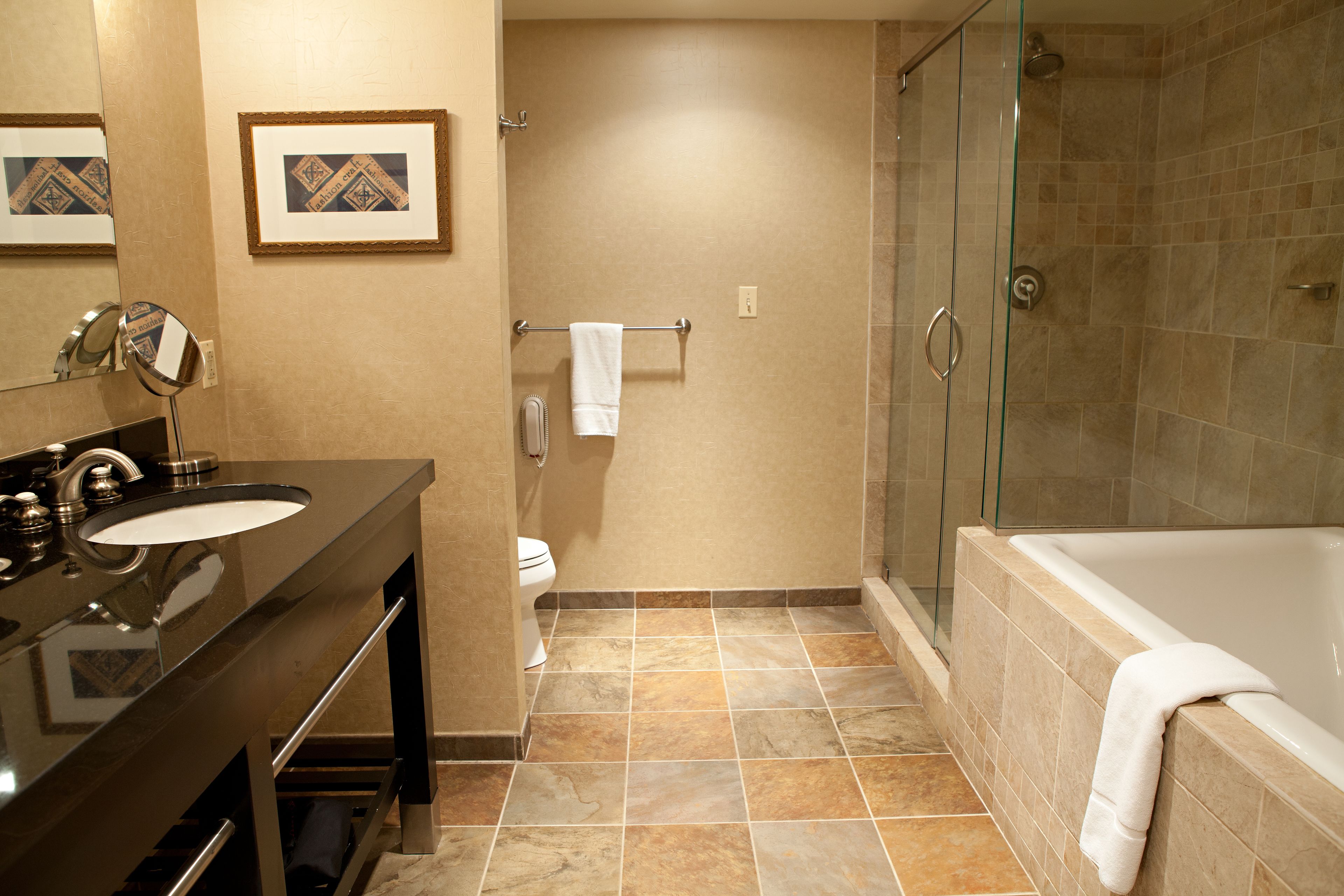 king suite | bathroom | combined shower/bathtub, designer toiletries, hair dryer, bathrobes