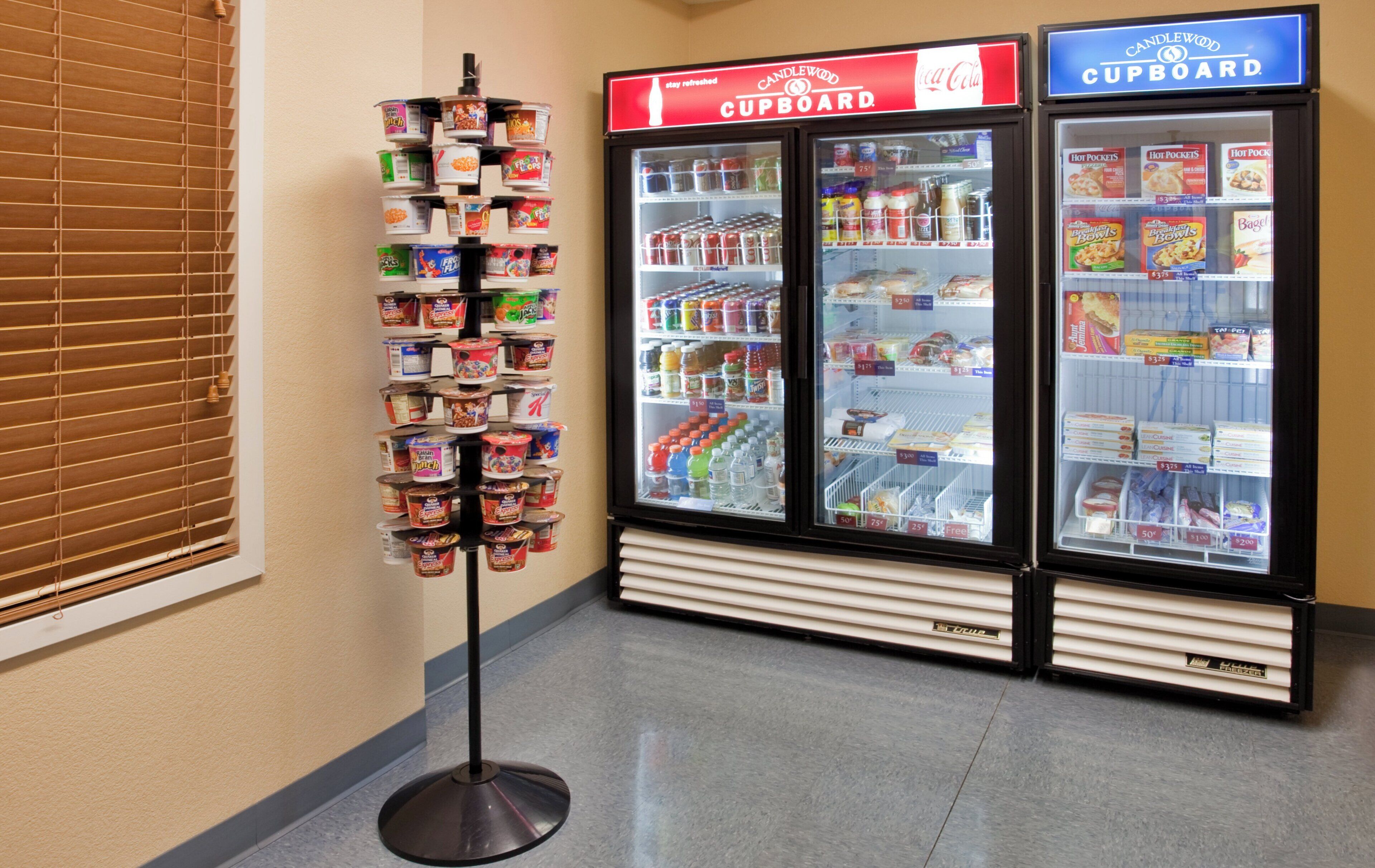 A display stand with various food products in a store aisle.