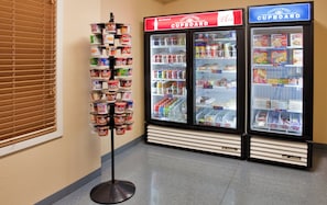 A display stand with various food products in a store aisle.