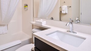A modern bathroom with a sink, mirror, and towel rack. - Candlewood Suites Sierra Vista by IHG (Sierra Vista)