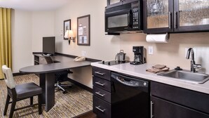 A compact hotel room with a kitchenette, a dining area, and a single bed. - Candlewood Suites Sierra Vista by IHG (Sierra Vista)