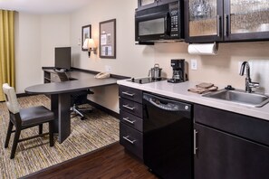 A compact hotel room with a kitchenette, a dining area, and a single bed. - Candlewood Suites Sierra Vista by IHG (Sierra Vista)