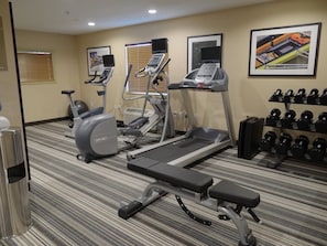 A gym with treadmills, an elliptical, a bench, and a rack of dumbbells. - Candlewood Suites Sierra Vista by IHG (Sierra Vista)