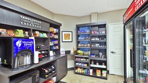 A snack bar with a variety of packaged foods and a coffee machine. - Candlewood Suites Indianapolis Airport by IHG (Indianapolis)